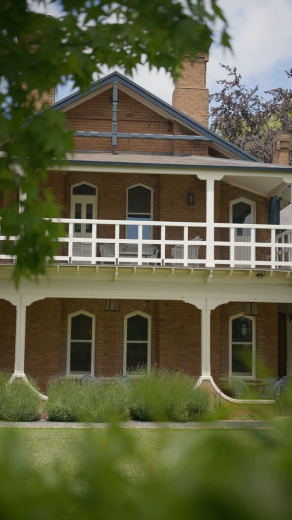Brick house with white veranda and garden view